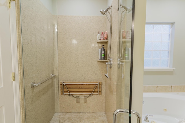 bathroom with a jetted tub and a stall shower
