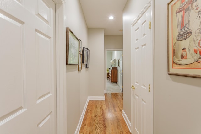 hall with light wood-type flooring, recessed lighting, and baseboards