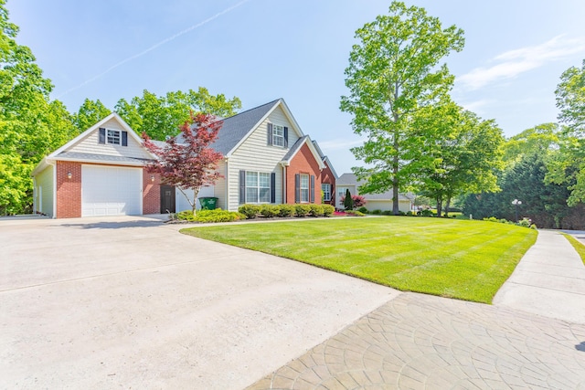 view of front facade featuring driveway, a front lawn, and brick siding