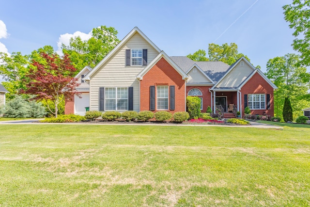 view of front of house featuring a front yard and brick siding