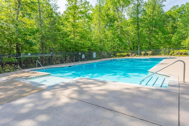 pool featuring a patio and fence