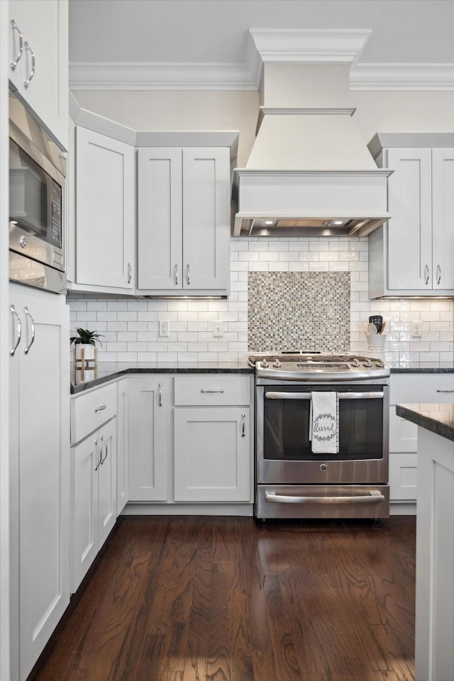 kitchen with custom exhaust hood, appliances with stainless steel finishes, and crown molding