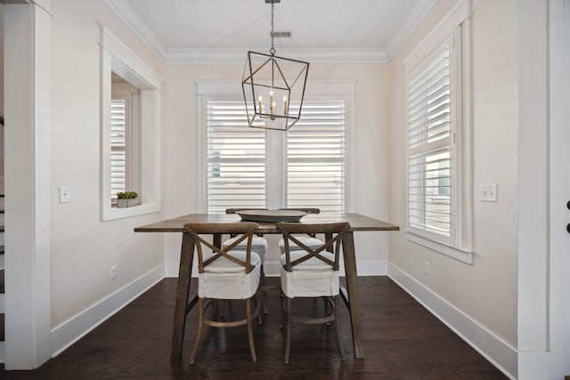 dining space with dark wood finished floors, an inviting chandelier, and ornamental molding