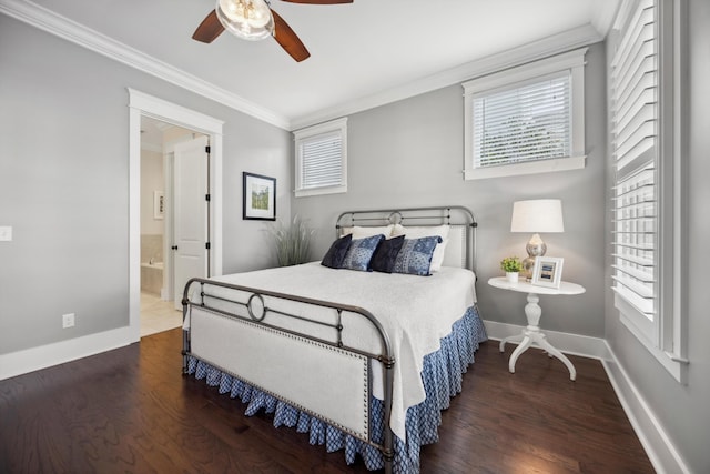 bedroom featuring connected bathroom, baseboards, wood finished floors, and ornamental molding