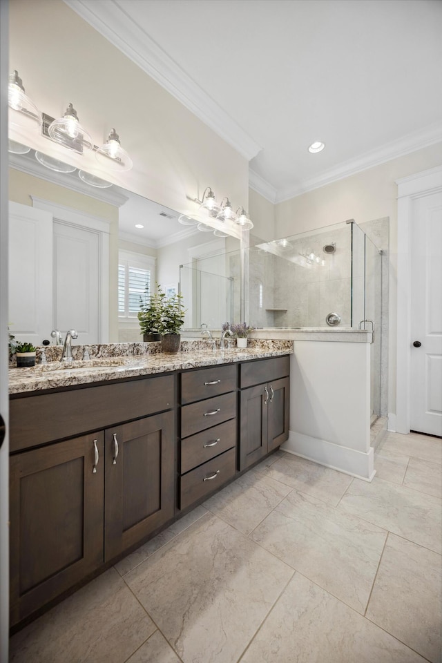 full bath featuring a shower stall, crown molding, and double vanity