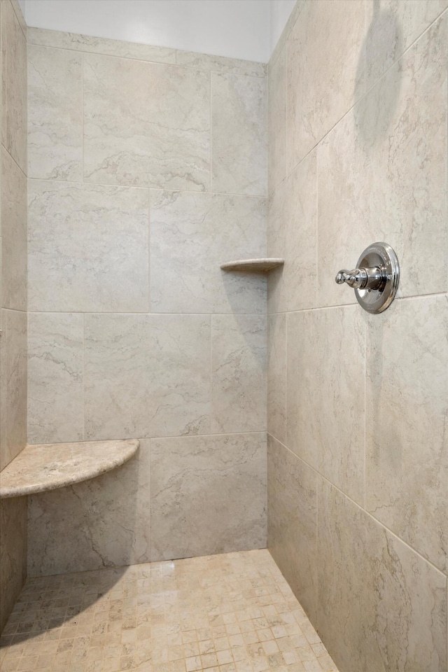 bathroom with a tile shower