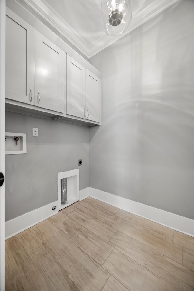 clothes washing area with wood finished floors, cabinet space, ornamental molding, washer hookup, and electric dryer hookup