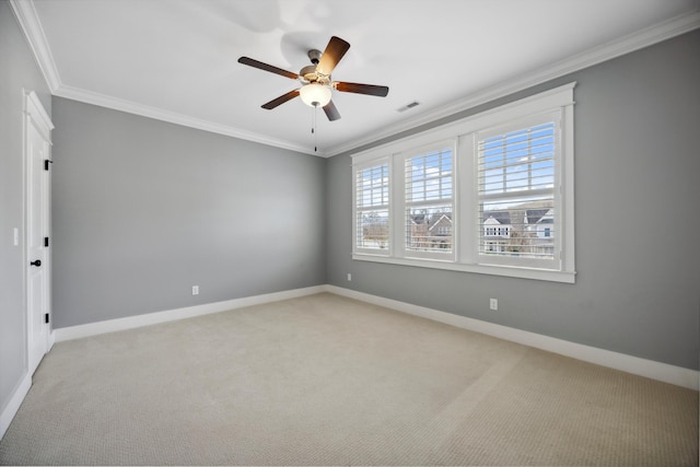 spare room with ceiling fan, visible vents, and ornamental molding