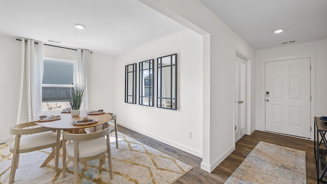 dining room with visible vents, plenty of natural light, and dark wood-style flooring