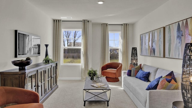 carpeted living room with visible vents and baseboards