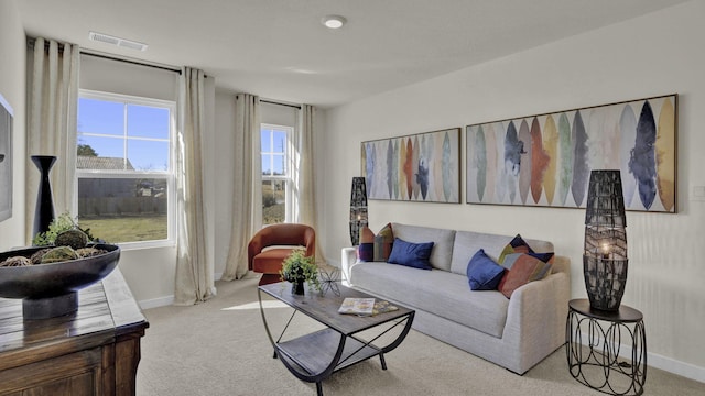 living area with carpet flooring, baseboards, and visible vents