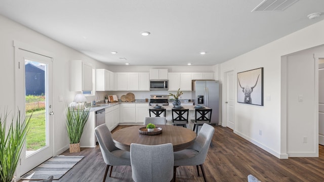 dining room featuring recessed lighting, baseboards, visible vents, and dark wood-style flooring