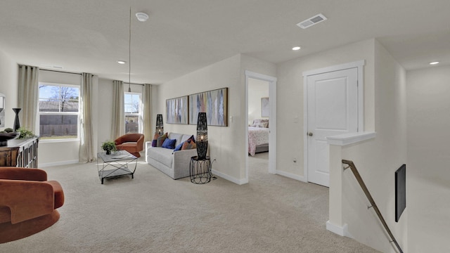 living room with visible vents, baseboards, and carpet flooring