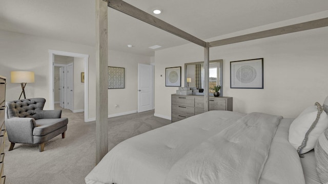 carpeted bedroom with beamed ceiling and baseboards