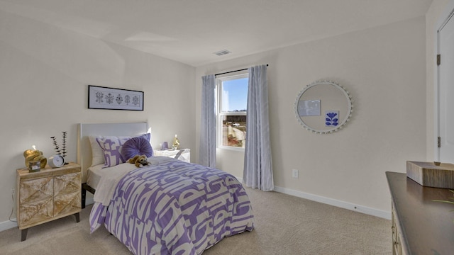 bedroom with visible vents, light colored carpet, and baseboards