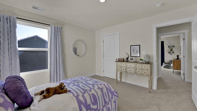 bedroom featuring light carpet, visible vents, and baseboards