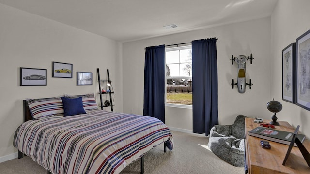 carpeted bedroom with visible vents and baseboards