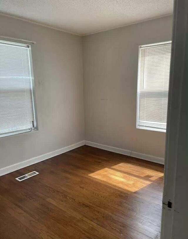 4922 Marylin Ln, Chattanooga, TN 37411 - spare room with wood finished floors, baseboards, and a textured ceiling