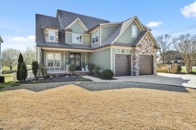 craftsman house with covered porch, driveway, and roof with shingles