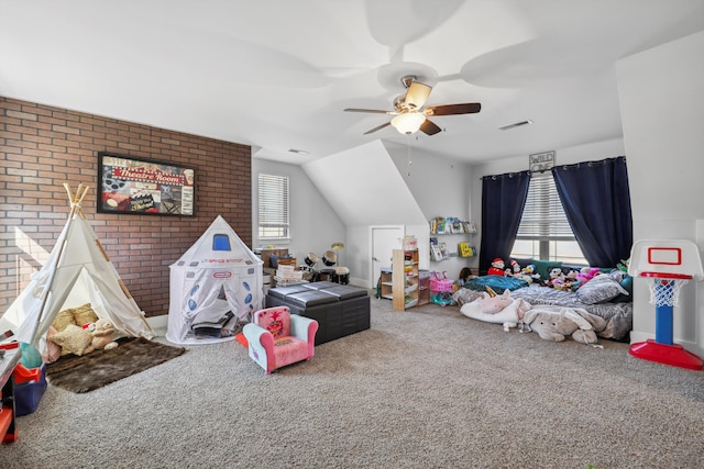 playroom featuring carpet floors, ceiling fan, visible vents, and lofted ceiling