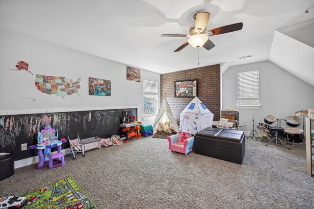 rec room with visible vents, carpet floors, vaulted ceiling, and ceiling fan