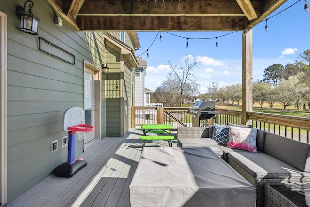 wooden deck with an outdoor living space and grilling area