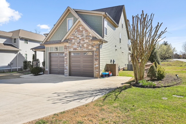 view of home's exterior with a yard, central AC unit, stone siding, and driveway