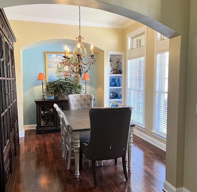 1760 Holden Farm Pl, Ooltewah, TN 37363 - dining area featuring dark wood finished floors, a notable chandelier, arched walkways, and crown molding
