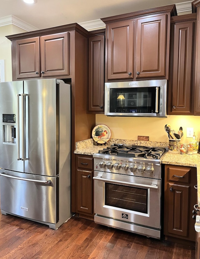 1760 Holden Farm Pl, Ooltewah, TN 37363 - kitchen featuring crown molding, light stone counters, dark wood-style floors, and stainless steel appliances