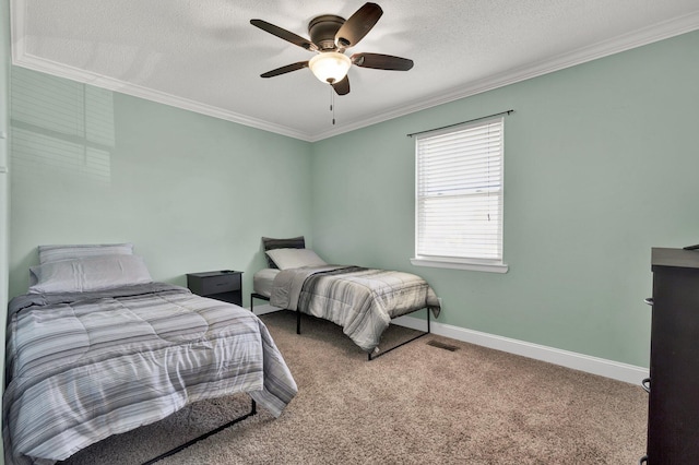 carpeted bedroom with ceiling fan, baseboards, a textured ceiling, and ornamental molding