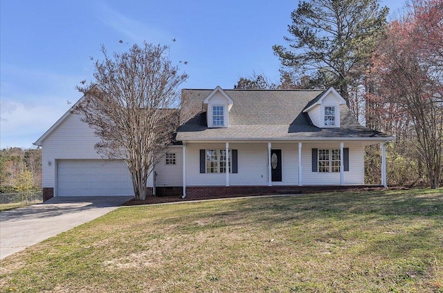 view of front facade featuring driveway, a front yard, covered porch, and an attached garage