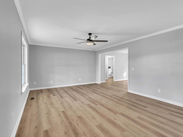 unfurnished room featuring crown molding, baseboards, visible vents, light wood-style flooring, and ceiling fan
