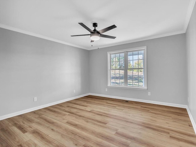 empty room with baseboards, light wood-type flooring, crown molding, and a ceiling fan