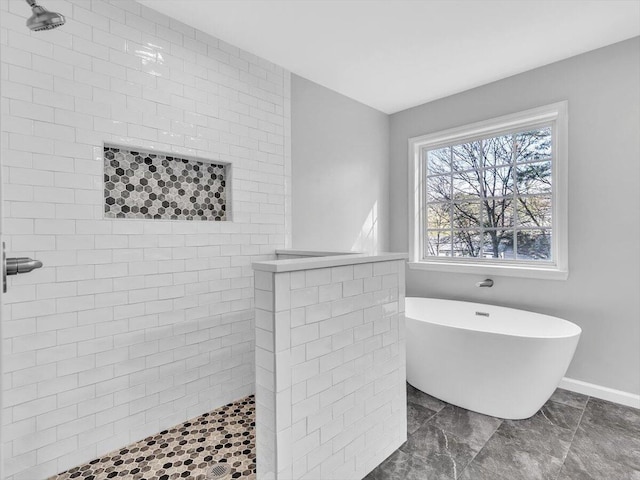 full bath with baseboards, a tile shower, and a freestanding tub
