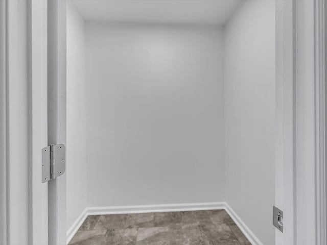 spare room with baseboards