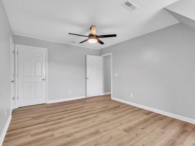 unfurnished bedroom with light wood-style flooring, baseboards, ceiling fan, and visible vents