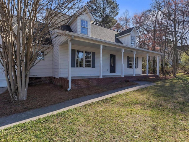 view of front facade with a shingled roof, crawl space, a front yard, and a porch