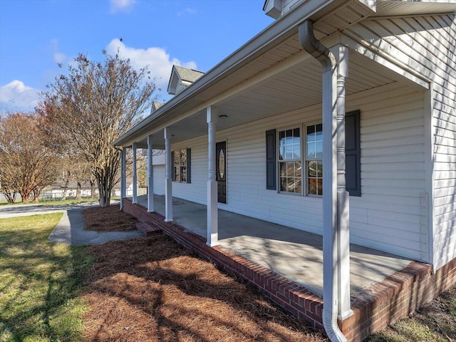 view of side of home with covered porch