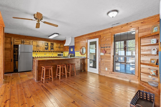 2345 County Rd 865, Gaylesville, AL 35973 - kitchen with a peninsula, light wood finished floors, visible vents, and freestanding refrigerator