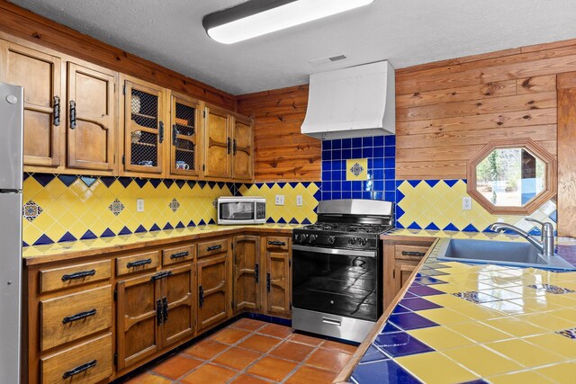 2345 County Rd 865, Gaylesville, AL 35973 - kitchen with tile countertops, premium range hood, a sink, appliances with stainless steel finishes, and backsplash