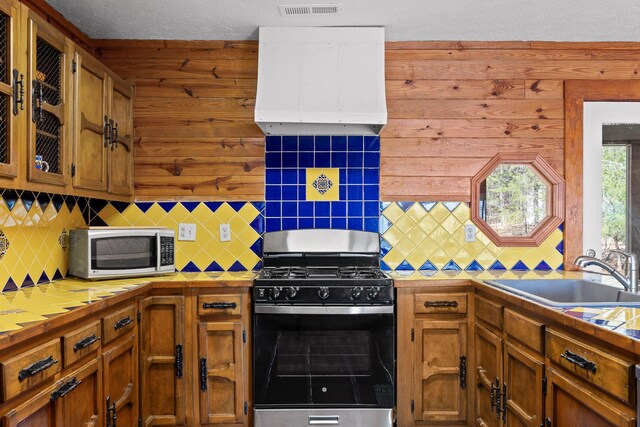 2345 County Rd 865, Gaylesville, AL 35973 - kitchen with a sink, range hood, tile countertops, stainless steel range with gas cooktop, and white microwave