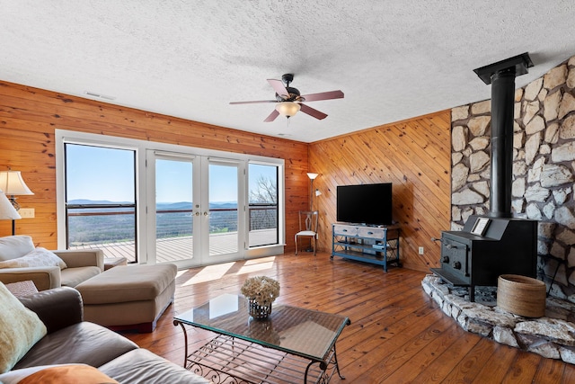 2345 County Rd 865, Gaylesville, AL 35973 - living room with visible vents, a wood stove, a ceiling fan, and hardwood / wood-style flooring
