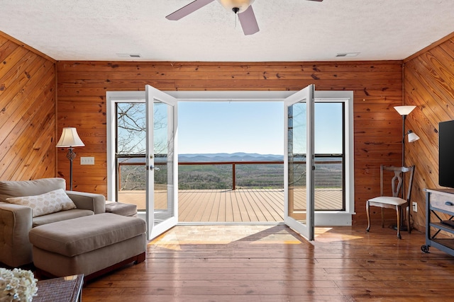 2345 County Rd 865, Gaylesville, AL 35973 - interior space with wooden walls, a textured ceiling, a ceiling fan, and wood-type flooring