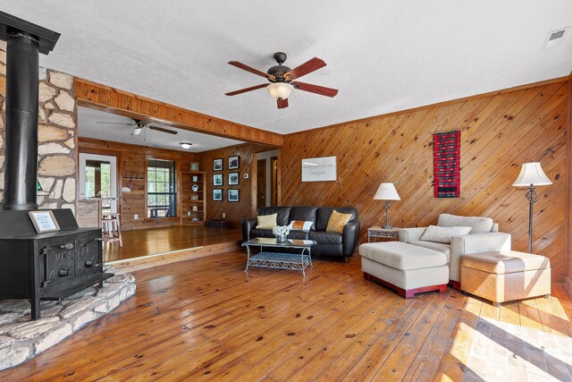 2345 County Rd 865, Gaylesville, AL 35973 - living area with visible vents, a wood stove, ceiling fan, and hardwood / wood-style flooring