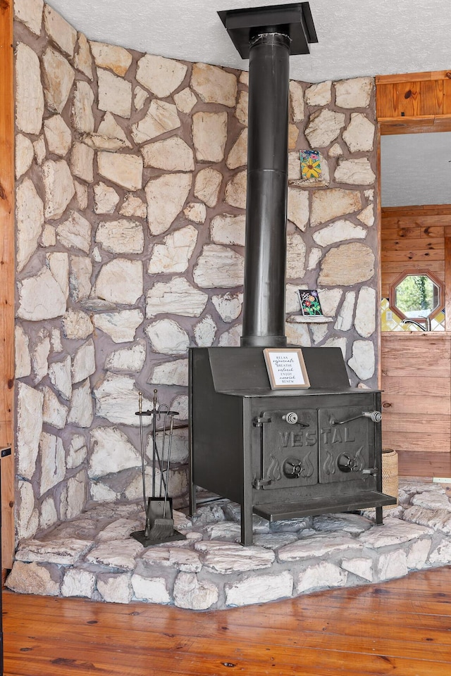 2345 County Rd 865, Gaylesville, AL 35973 - details with a textured ceiling, wood finished floors, and a wood stove