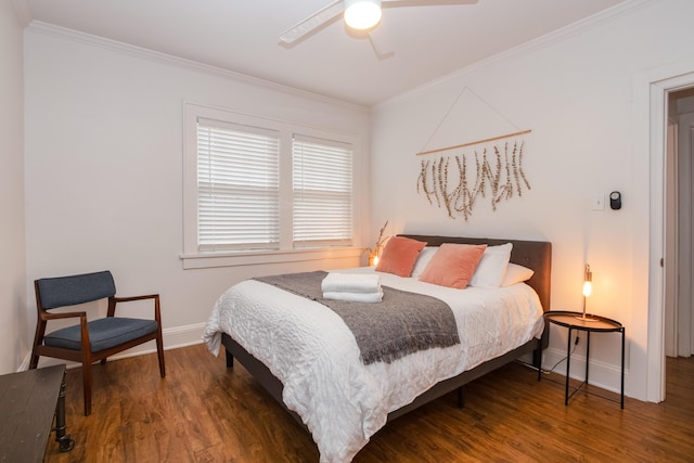 bedroom with baseboards, crown molding, wood finished floors, and a ceiling fan