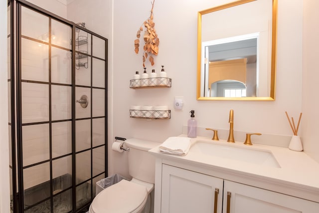 full bathroom featuring a tile shower, toilet, and vanity
