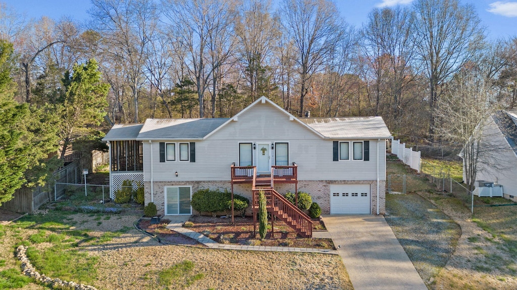 2125 Dallas Lake Rd, Soddy Daisy, TN 37379 - single story home with stairway, a garage, driveway, a sunroom, and fence