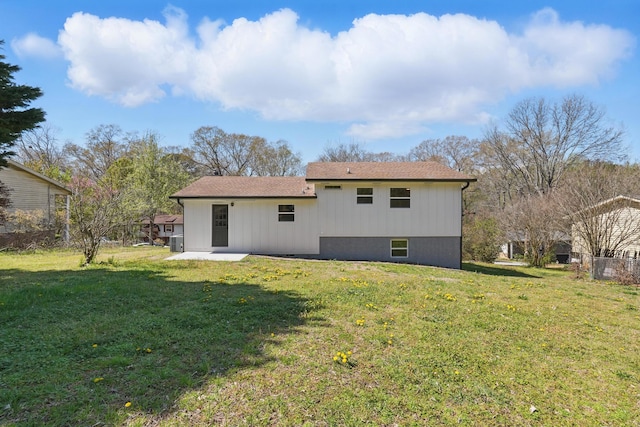 rear view of house with a patio and a yard