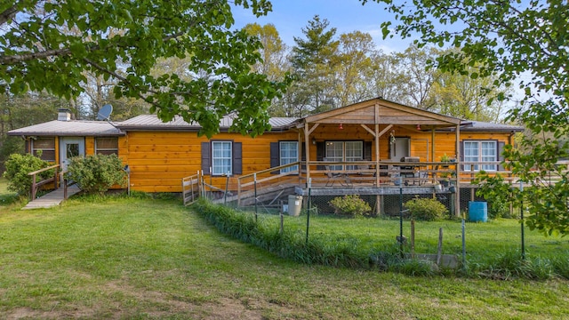 105 Massingale Rd, Tellico Plains, TN 37385 - rear view of property featuring metal roof and a yard